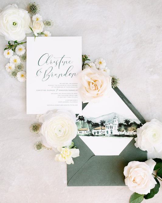 Wedding invitation card with envelope and floral decorations on a light background